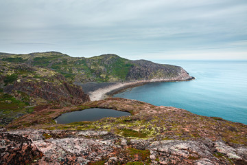 View on the rocky shore of the Barents sea. Kola Peninsula, The Arctic, Russia.