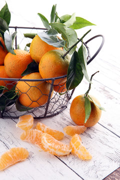 Tangerines with leaves on wooden background. Mandarins Rustic st