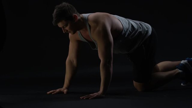  Fit young man with muscular physique doing press ups
