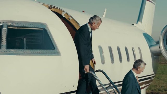 Mixed ethnicity VIP Businessmen disembarking from private jet