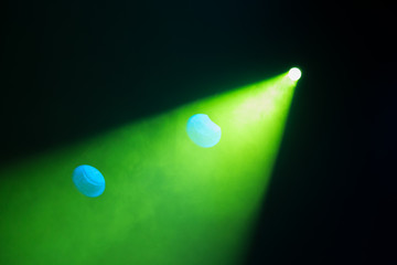 Rays theatrical spotlights on the stage during the performance. Lighting equipment. The lighting designer. Theatrical smoke. The art and creativity.