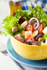 Fresh salad with mixed greens and cherry tomato in bowl