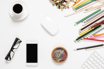 Messy office desk with empty cellphone