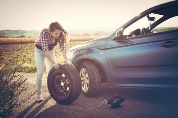 Fototapeta na wymiar Beautiful young woman on the road, problem with her car