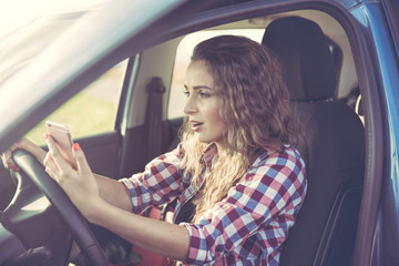Naklejka premium A nervous young woman in the car