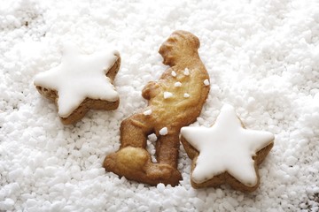 Fototapeta na wymiar Speculaas biscuit, Dutch cookie in the shape of a man with coarse sugar and cinnamon star cookies