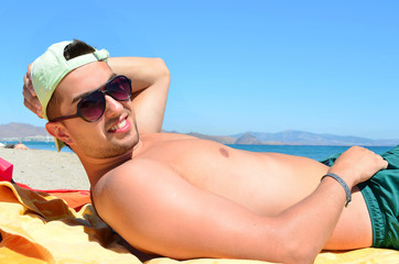 handsome young  man sunbathing  on the beach.Summer vacation