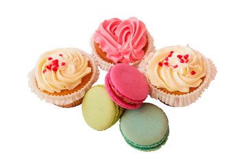 Macaroons and cupcakes isolated on white background. Selective focus.