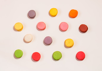 Colorful macaroons pattern on beige background