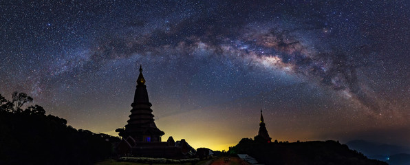 Panorama view of Milky way on top of King and Queen Pagodas at Doi Inthanon National Park, Chiang Mai, Thailand..