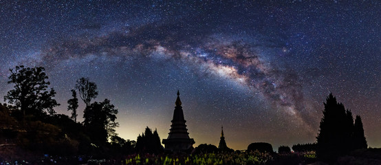 Panorama view of Milky way on top of King and Queen Pagodas at Doi Inthanon National Park, Chiang Mai, Thailand..