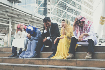 Multiethnic group of businesspeople sitting sad and solving problem