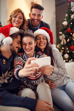 Group of young people making Christmas selfie