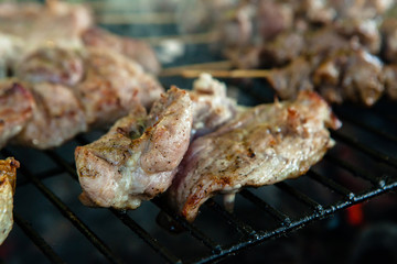 Hot juicy chicken steaks on the grill with seasoning on the grill