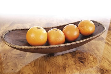 Oranges in a wooden bowl