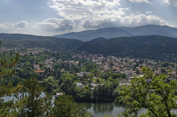 Fototapeta na wymiar Scene with mountain, lake, glade, forest and residential district of bulgarian village Pancharevo, Sofia, Bulgaria 