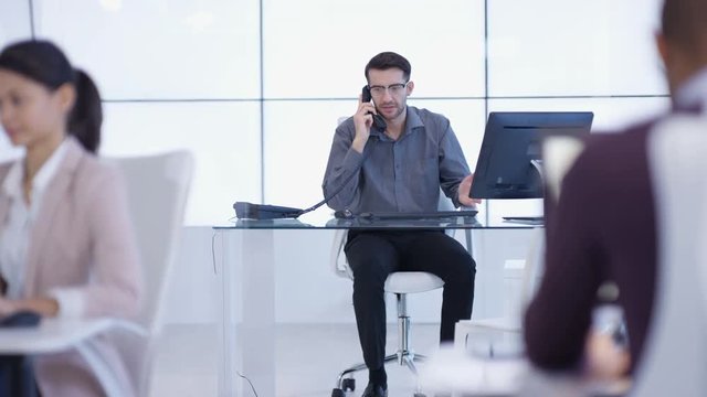  Business group working in office, pregnant woman talking a colleague