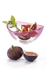 Fresh Figs (Ficus carica) with rucolain a glass bowl