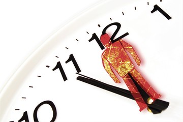 Clock showing five-to-twelve and superimposed red traffic light figure