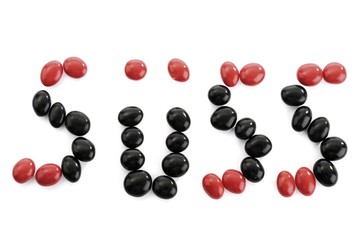 Red and black salmiak licorice candies arranged to spell 