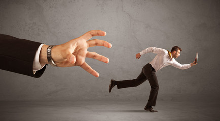 Businessman running from hand