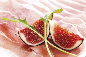 Fresh Figs (Ficua carica) with raw ham and rucola