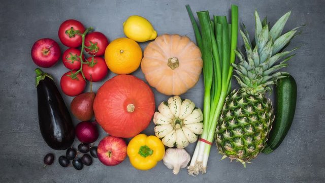 Top view on vegetables arranging into colourful border with empty space for your text. 4k stop motion animation loop.