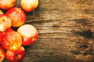 Ripe red apples on wooden background