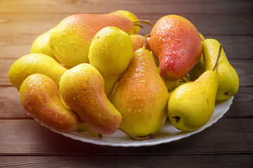 Ripe pears in a plate. 