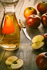 Fresh apple juice in the bottle on the wooden table