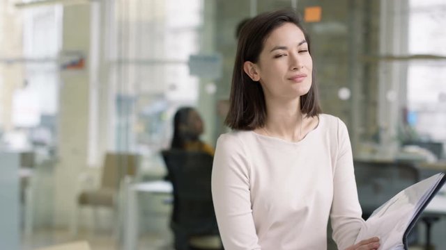  Portrait smiling casual businesswoman in modern creative office