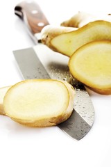 Sliced Ginger (Zingiber officinale) with a knife