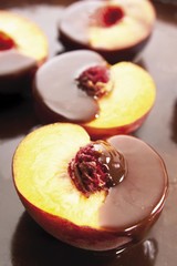 Peaches with a liquid chocolate coating