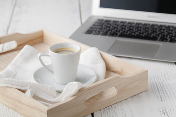 cup of espresso or coffee resting on a white serving tray