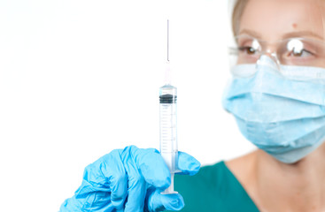 Female doctor with syringe.  Nurse  dials the vaccine into a syringe
