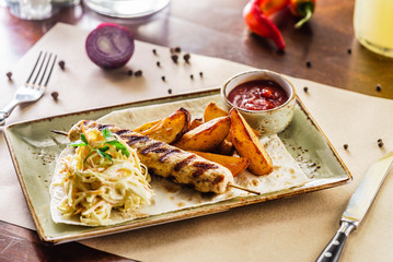 kebab with potatoes and salad