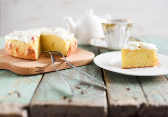 Tea time. Cup of tea with homemade apple cake with cream cheese served on shabby robin egg blue boards