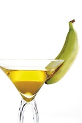 Banana liqueur in a cocktail glass with green banana garnish
