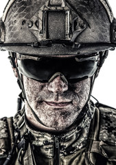 Close up studio shot of special forces soldier in field uniforms and combat helmet, portrait...