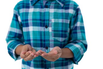 Boy pretending to hold invisible object against white background