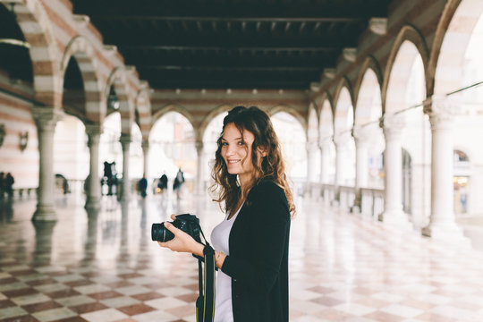 Pretty Young Female Photographer Taking Pictures in Italy