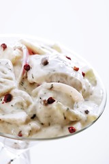 Danish dill snack topped with pink peppercorns in a glass