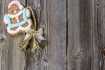Christmas Gingerbread Man and Bell on Wooden Background