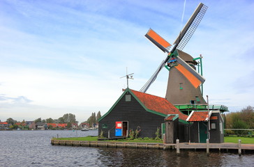 Traditional Dutch windmill on the water channel. Zaandam, the Netherlands. 