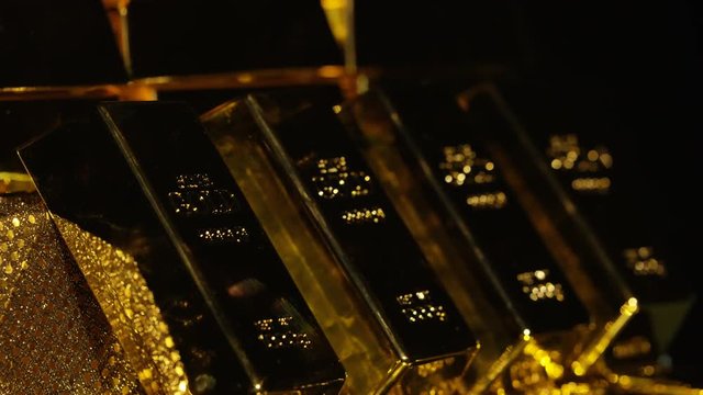  Close up gold bars on shimmering rotating stand, wealth & luxury concept. 