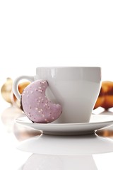 Coffee cup and half-moon shaped gingerbread cookie, Christmas balls at back