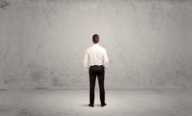 Businessman lost in empty urban space