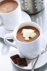White cups with chocolate and cream