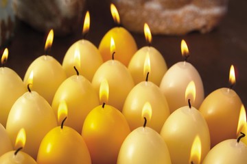 Lit candles, egg-shaped