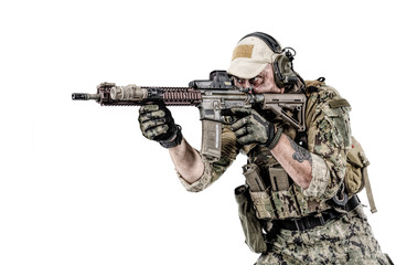 Half length low angle studio shot of special forces soldier in field uniforms with weapons,...